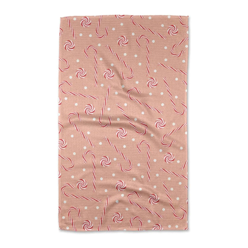 Geometry Pink Peppermint holiday kitchen tea towel, folded, front view.