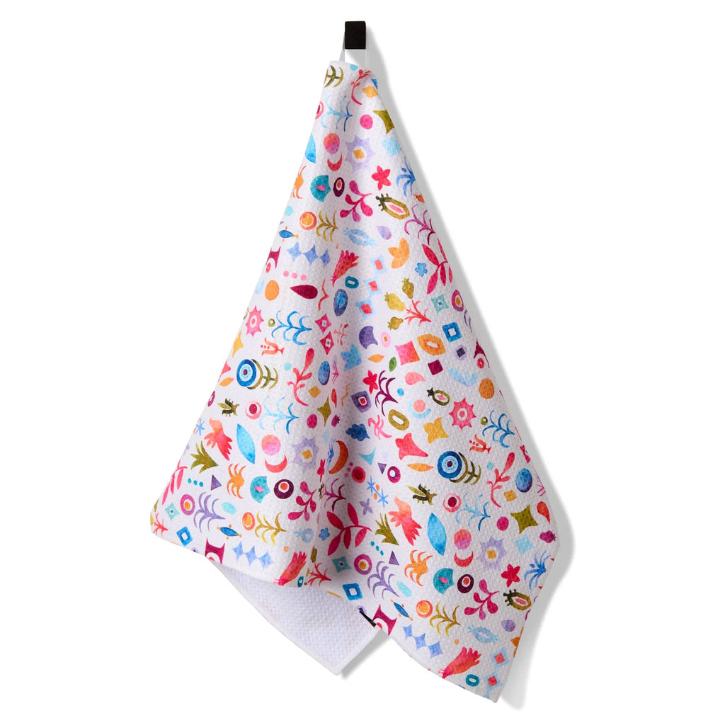 Geometry Tula eco-friendly kitchen tea towel with colorful symbols print, hanging on loop.