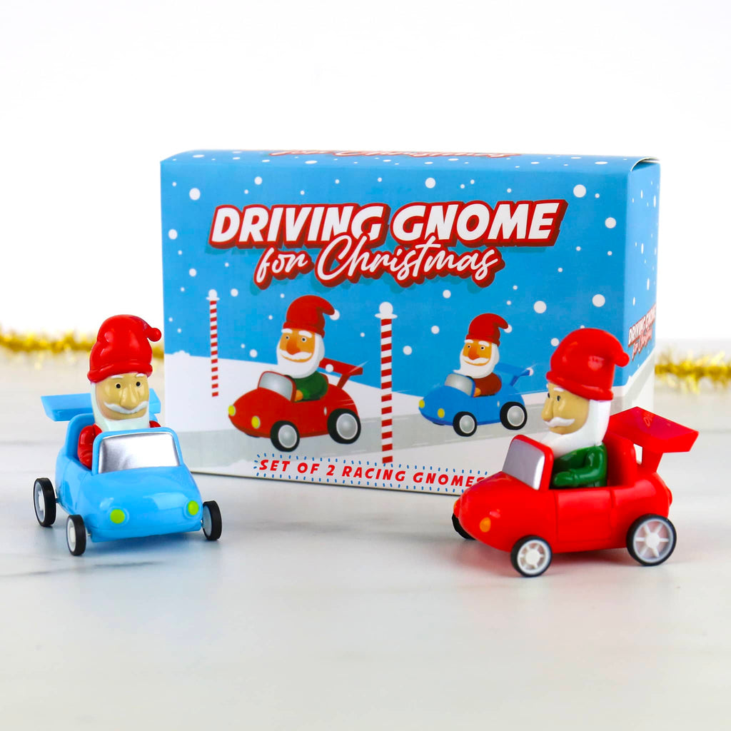 Set of two toy gnomes in cars with a box labeled 'Driving Gnome for Christmas' on a white background.