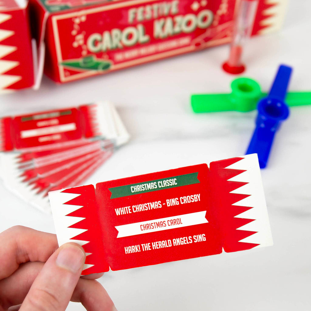 Gift Republic Festive Carol Kazoo holiday party game in cracker packaging, contents with sample card.