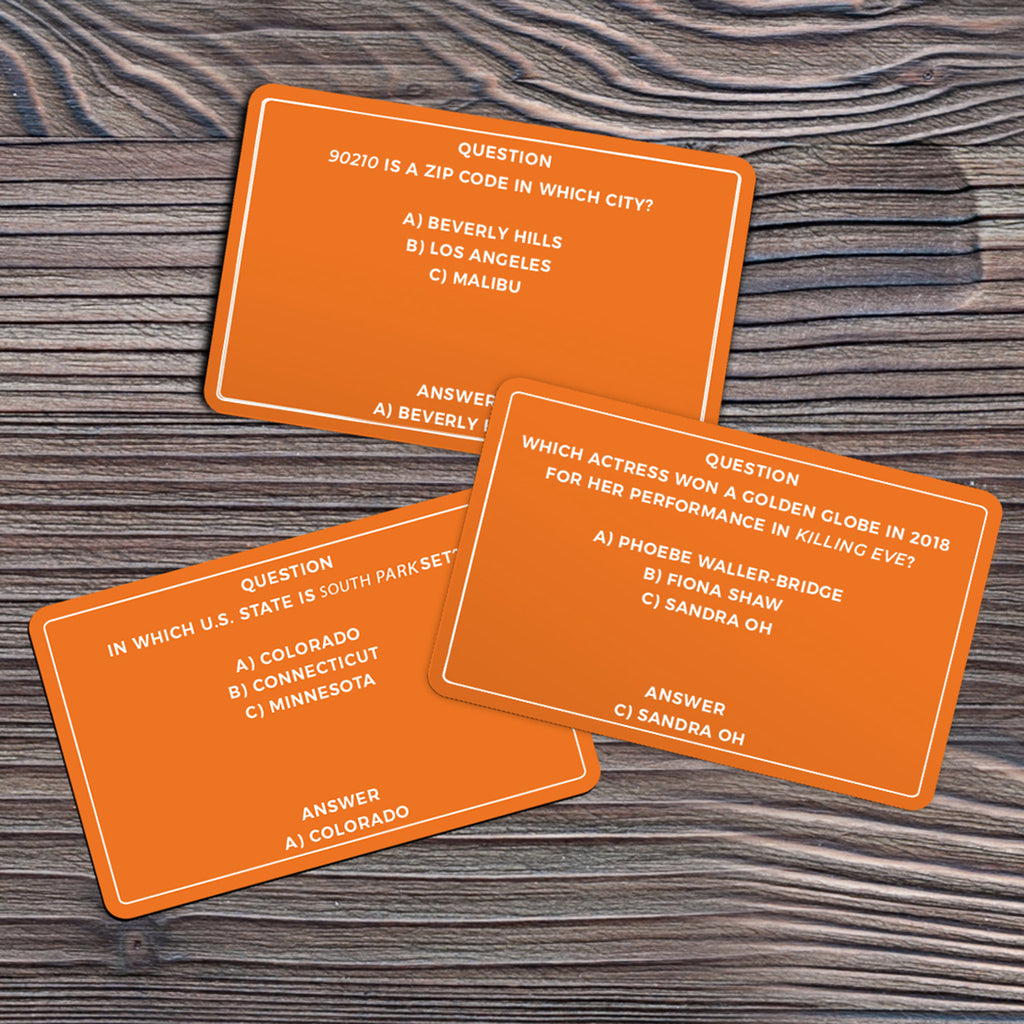 Gift Republic Ultimate TV Trivia, sample question cards on a wood background.
