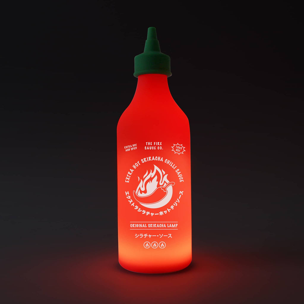 Gift Republic Chili Sauce Lamp, glowing in dark room.