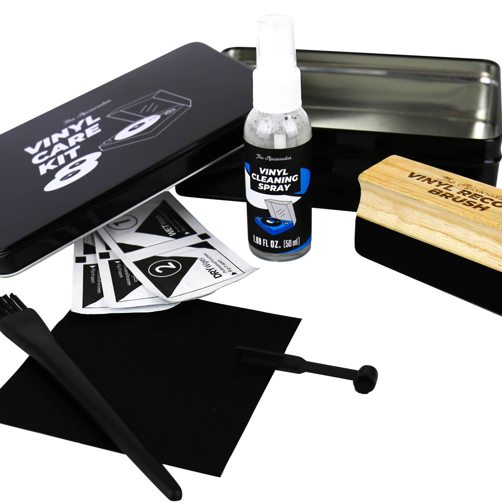 Gift Republic Vinyl Care Kit in black tin, lid is off and contents are arranged on a white background. Contents include a velvet record brush, stylus cleaning brush, microfiber cloth, bristle brush, cleaning spray and 3 sets of dry and wet wipes.