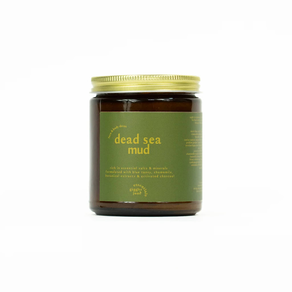 Ginger June Dead Sea Mud Mask for face and body detox in amber glass jar with gold screw-on lid and green label.