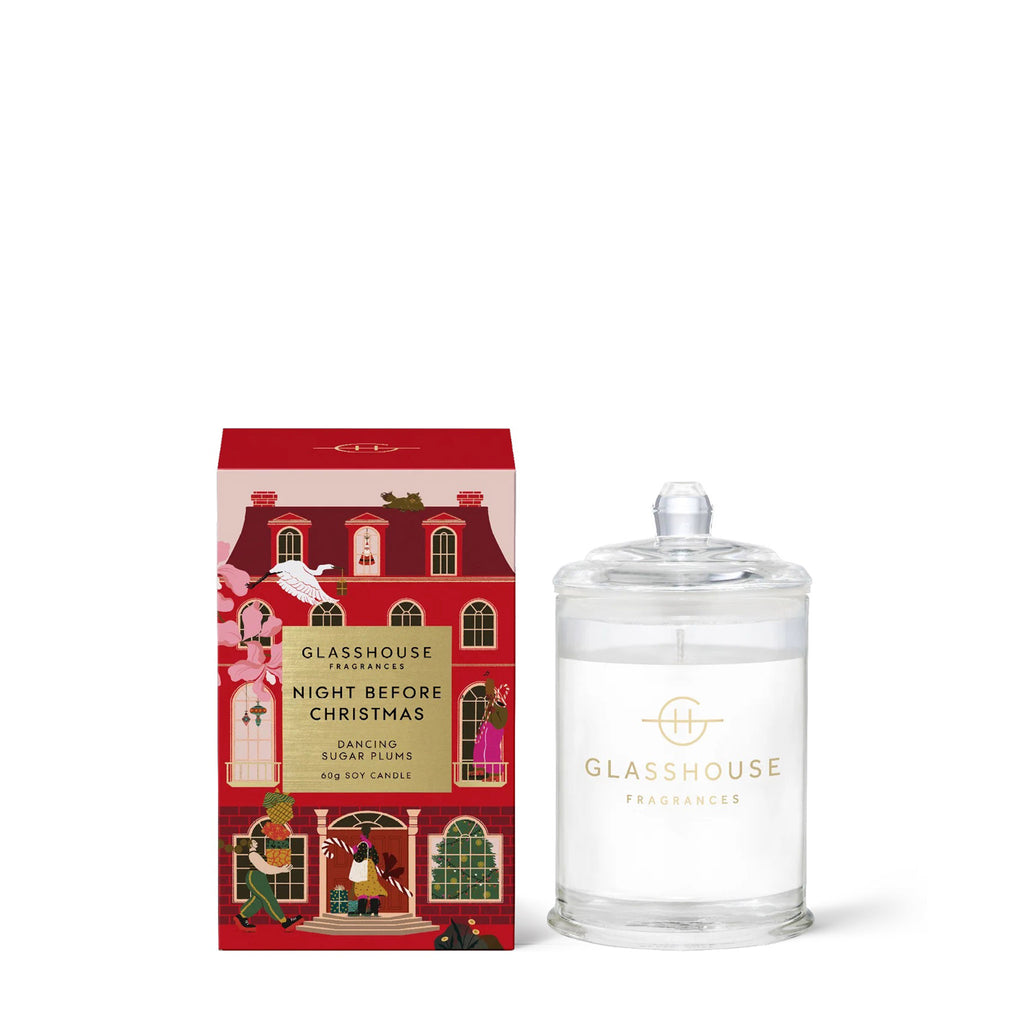 Glasshouse Fragrances Night Before Christmas Dancing Sugar Plums scented soy wax candle in clear glass jar with lid beside red and pink house illustrated gift box, front view.