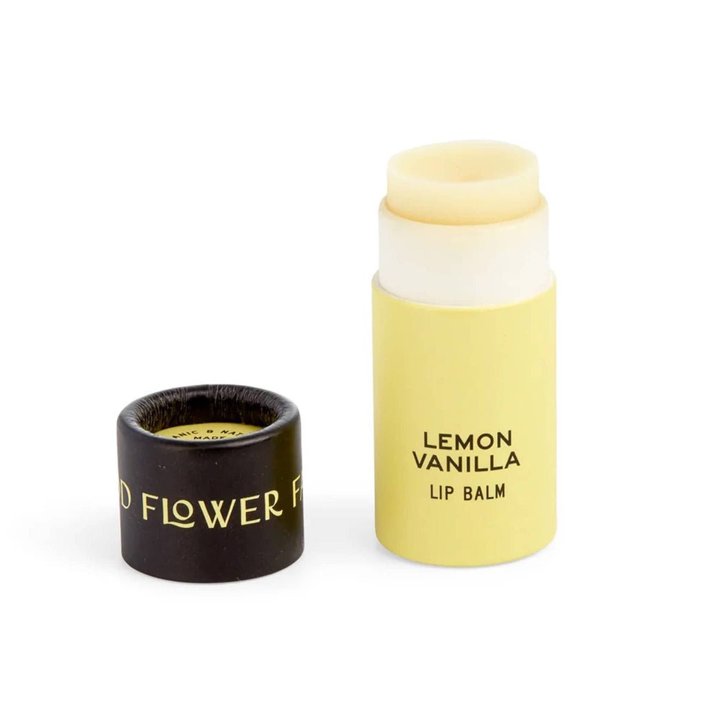 Good Flower Farm Lemon Vanilla scented lip balm in yellow paper tube packaging with lid off.