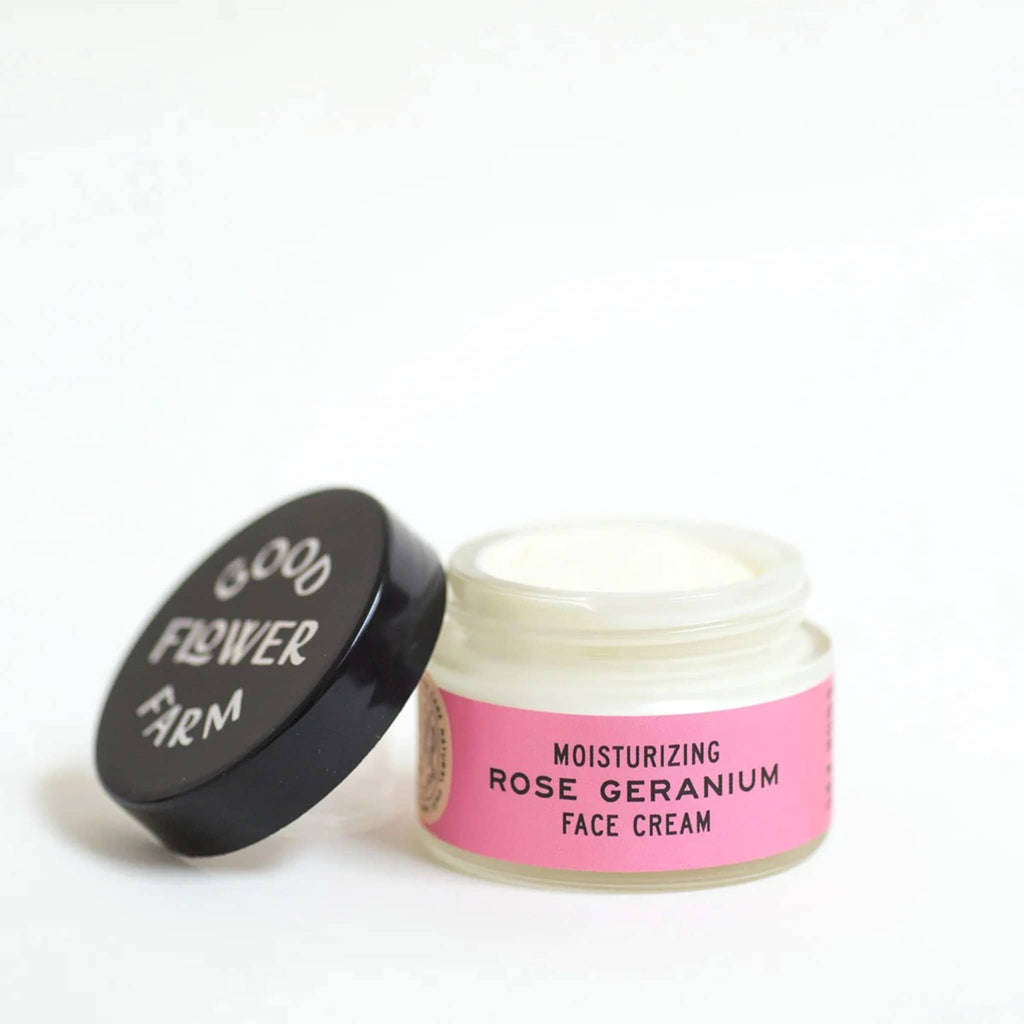 Good Flower Farm Moisturizing Rose Geranium Face Cream in glass jar with pink label, lid off.