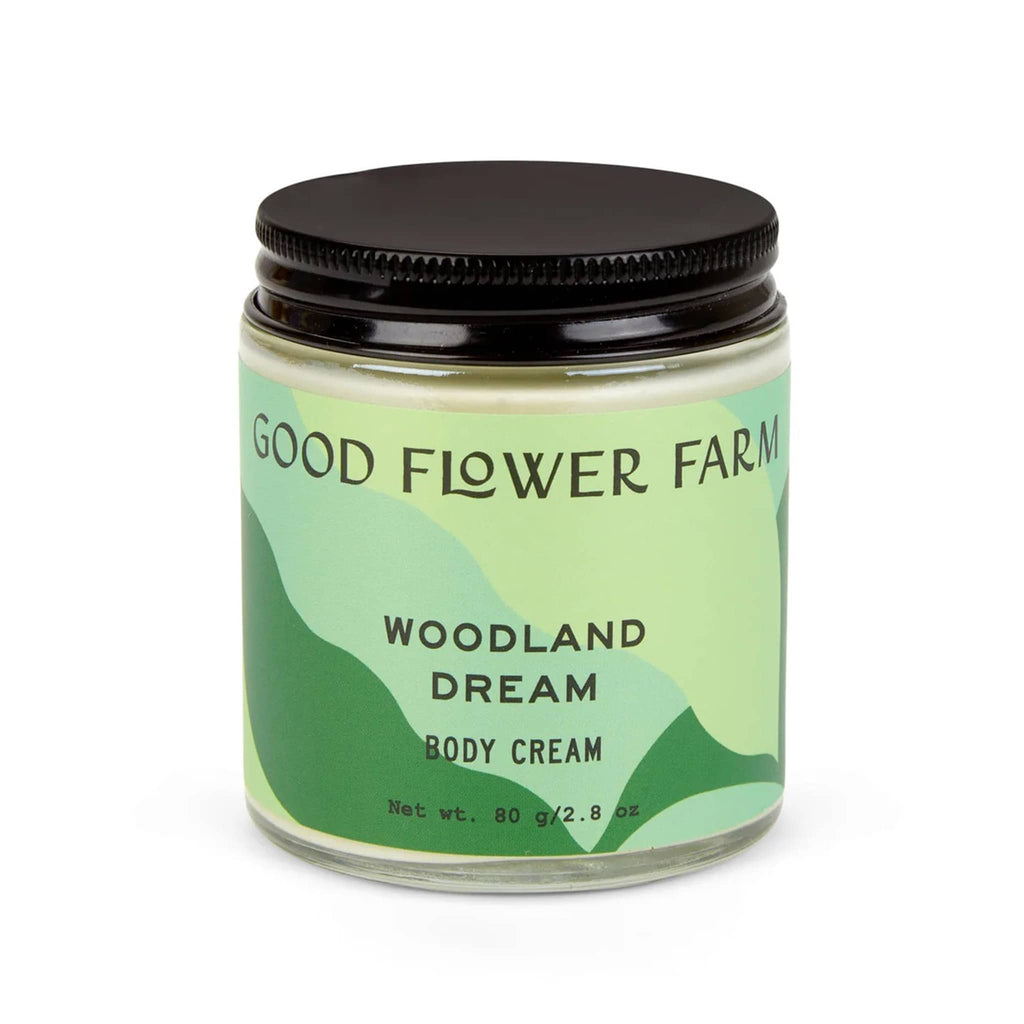 Good Flower Farm Woodland Dream Organic Body Cream in clear glass jar with green label.