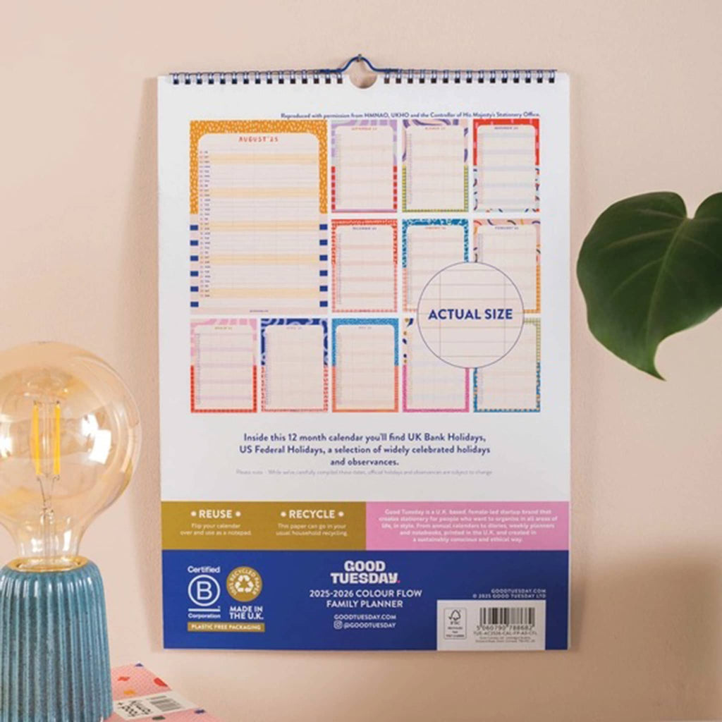 Family planner wall calendar back cover showing all month designs, hanging on a wall.