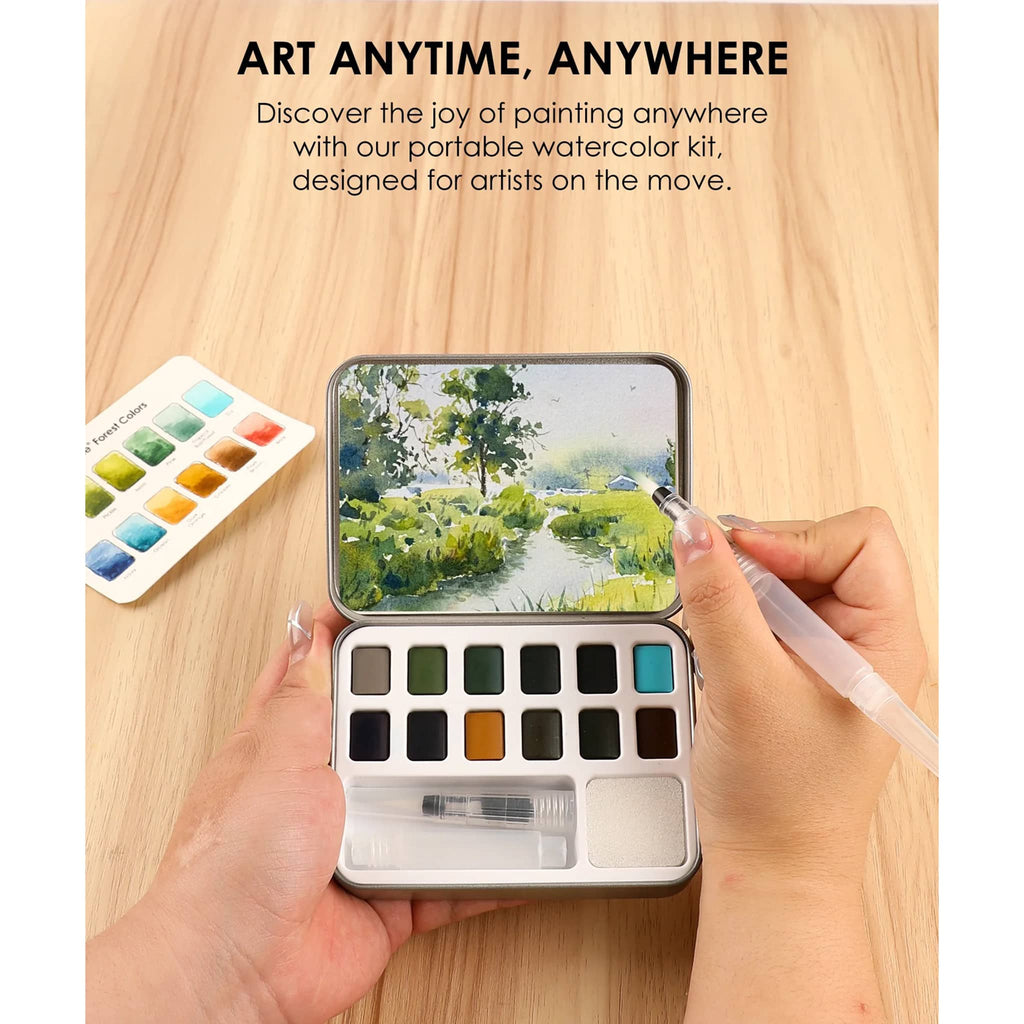 Portable watercolor kit with paint swatches and a hand holding a brush on a wooden surface.