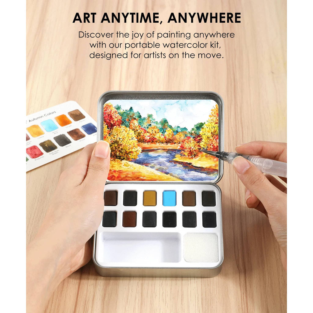 Portable watercolor kit with paint swatches and a scenic painting on a wooden surface.