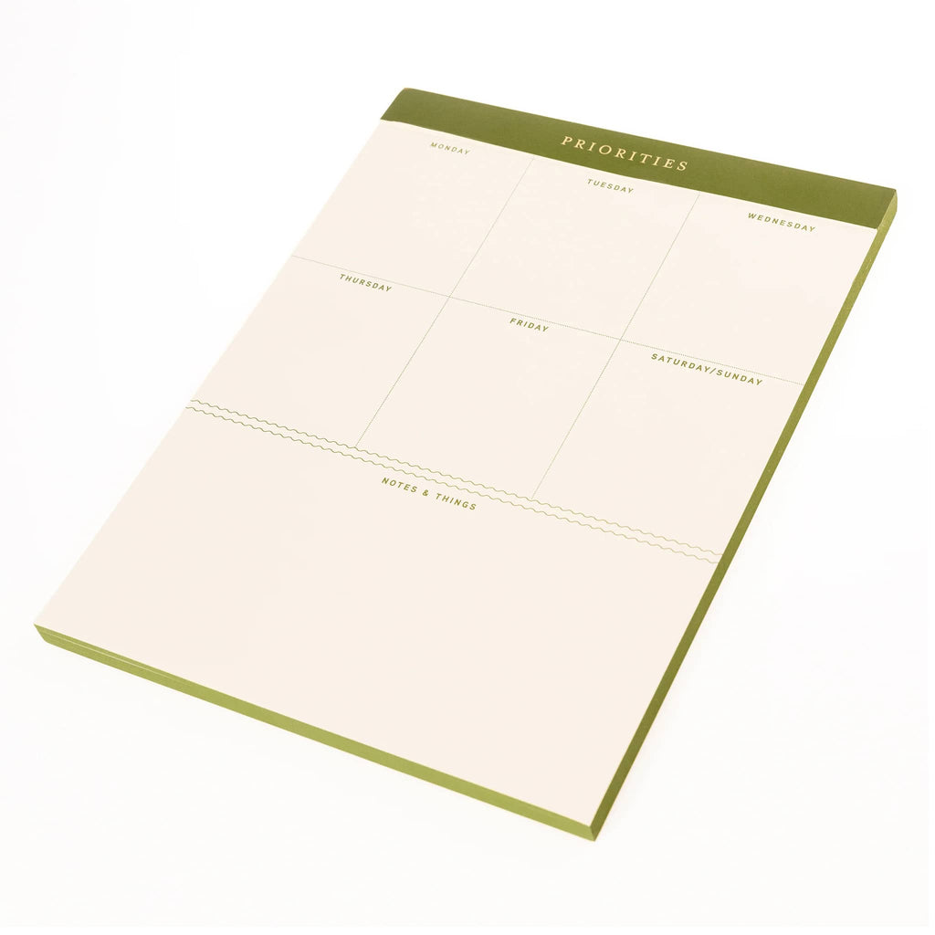 Weekly planner pad with green border on a white background.