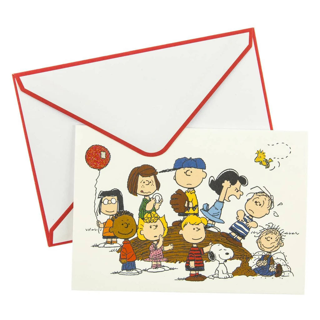 Greeting card with Peanuts characters around and on a pitching mound, with white envelope with red trim, on a white background.