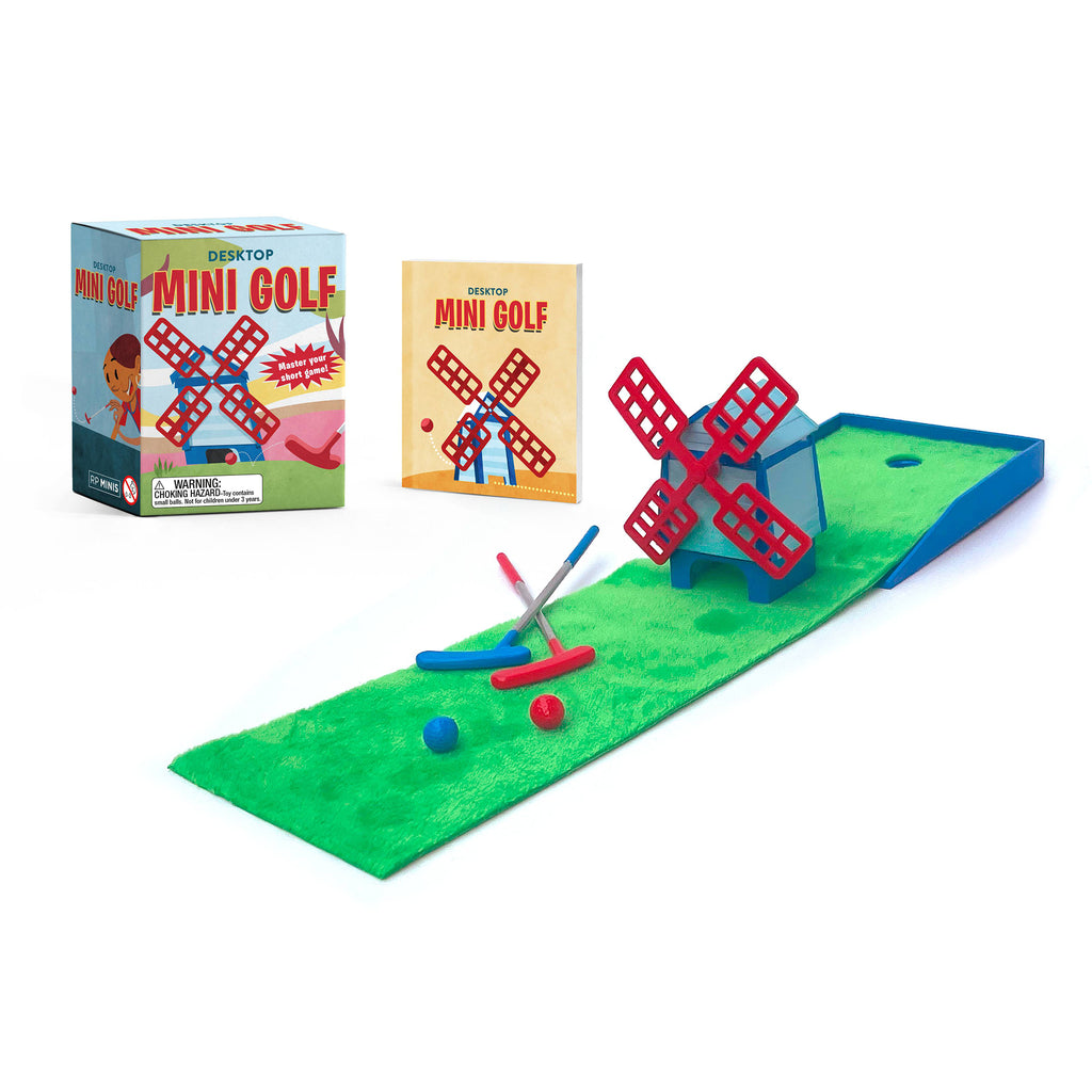 Hachette Desktop Mini Golf set with mini putting green, 2 putters, 2 golf balls, a mini windmill obstacle, mini book and box packaging.