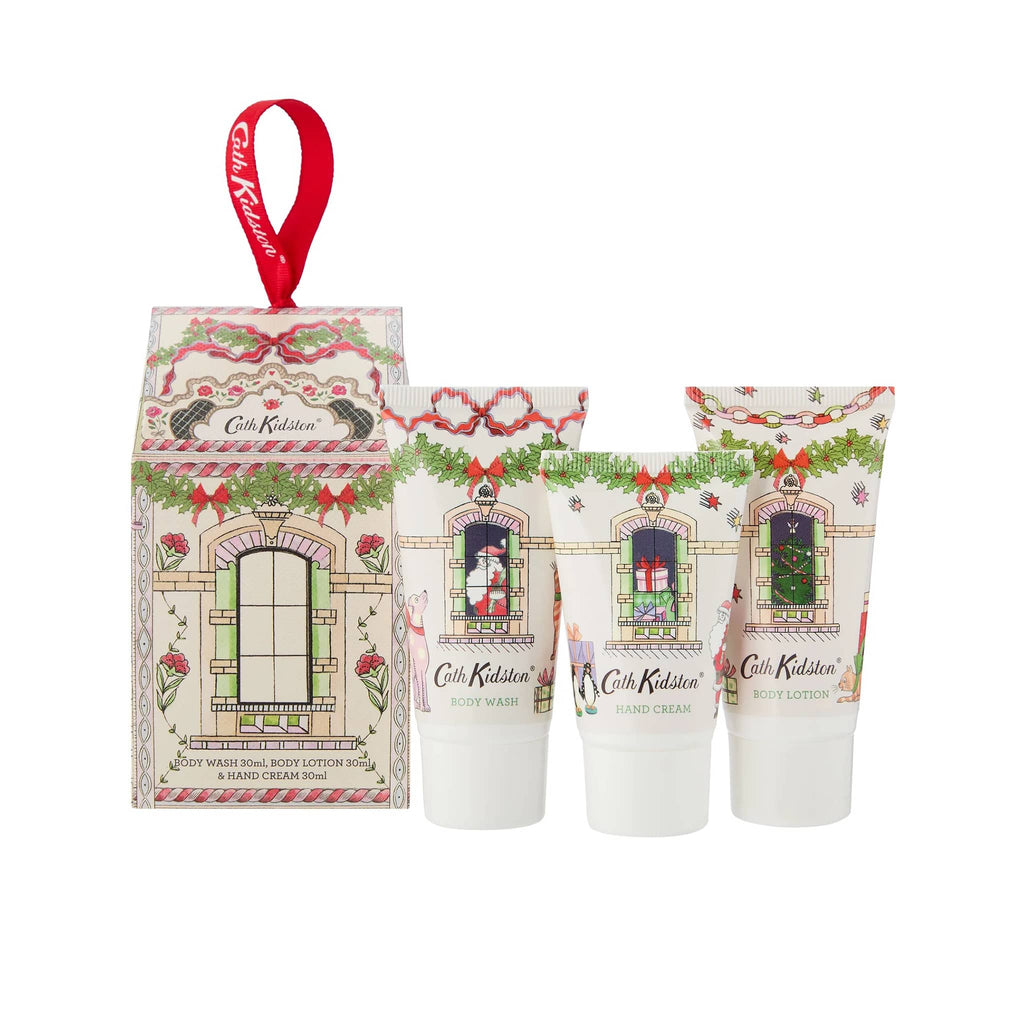 Heathcote & Ivory Cath Kidston A Doll's House Gift Set in house-shaped box packaging with ribbon hanging loop, front view, with tubes of body wash, hand cream and body lotion.