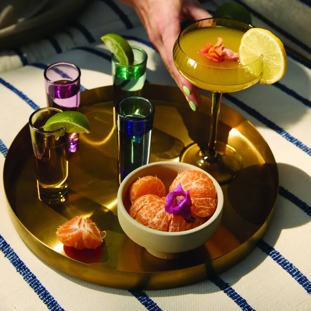 Here's How The Gracie Colorful Shot Glasses, set of 4 on a gold tray with a cocktail, lifestyle shot.