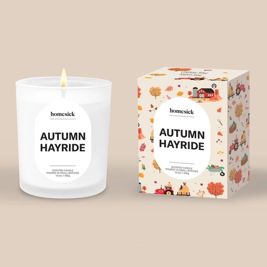 Homesick Autumn Hayride candle and packaging on a beige background.