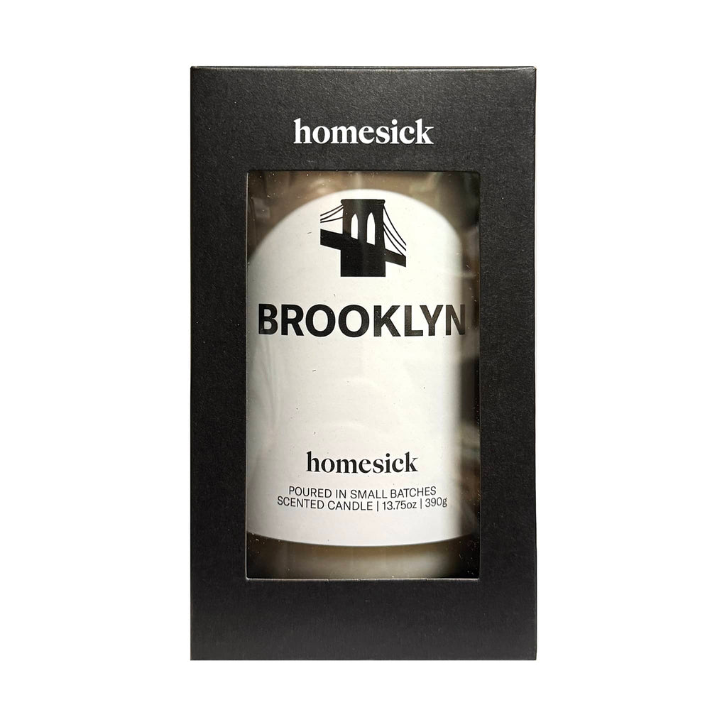 Homesick Brooklyn scented candle in packaging on a white background.