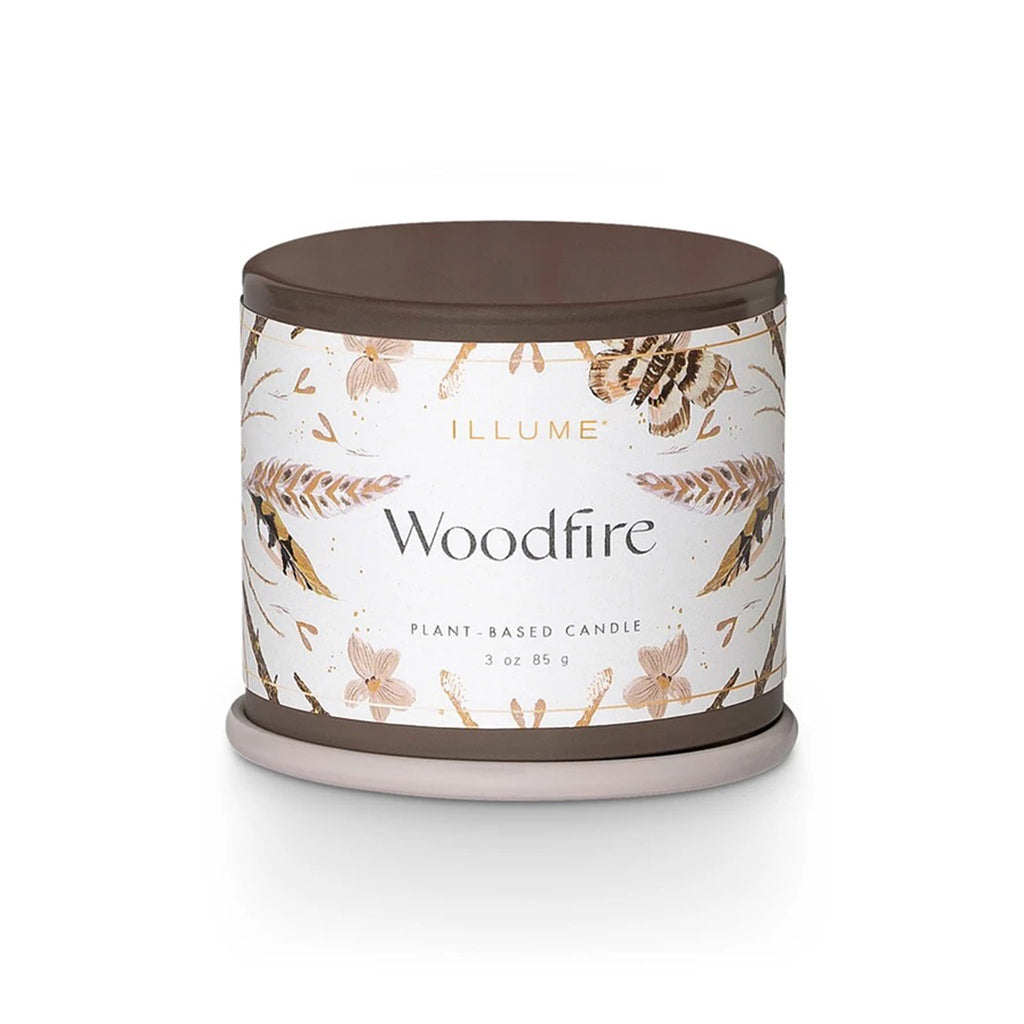 Illume Woodfire scented plant based wax candle in demi vanity tin, front view with lid on.
