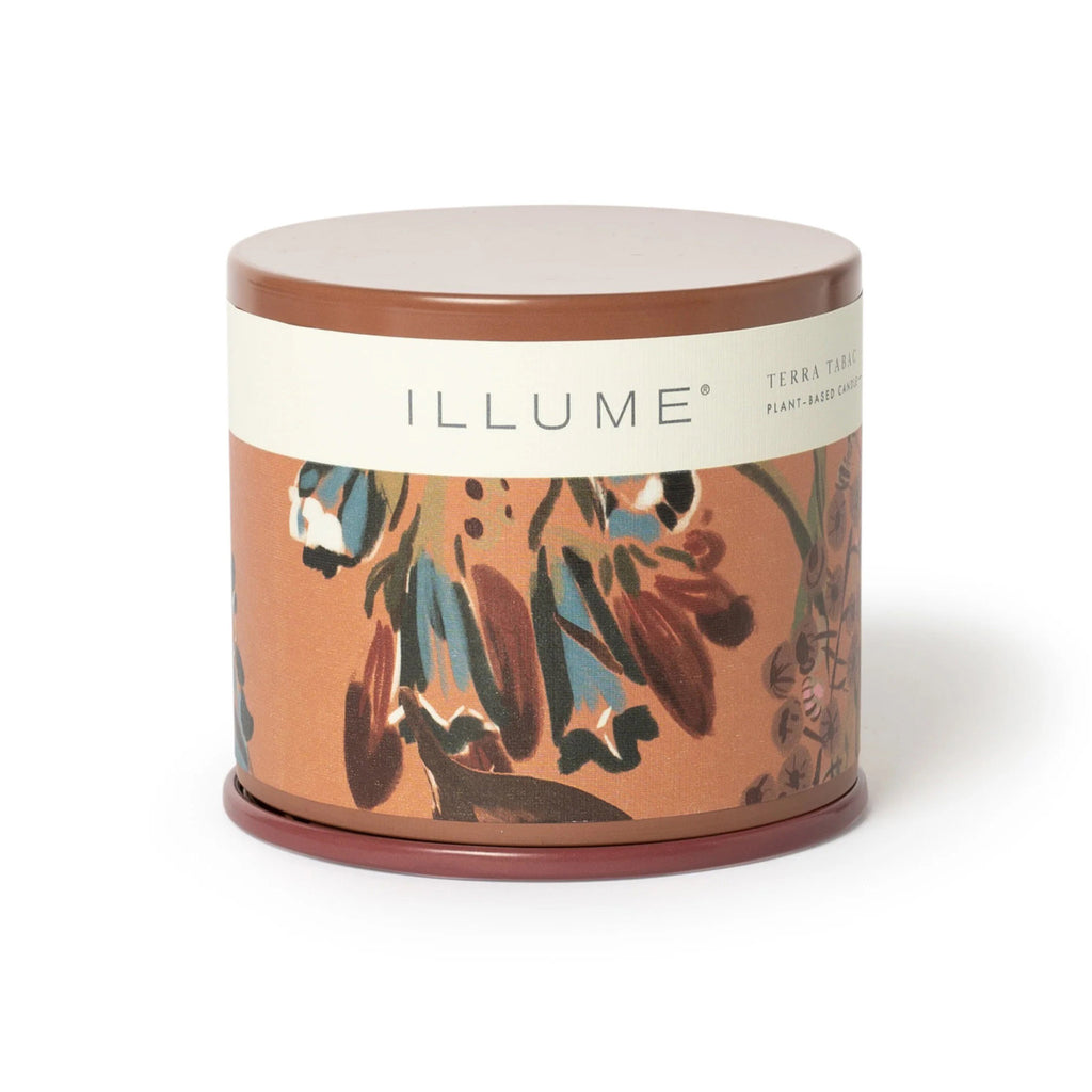 Illume Terra Tabac scented plant based wax candle in large vanity tin, front view with lid on.