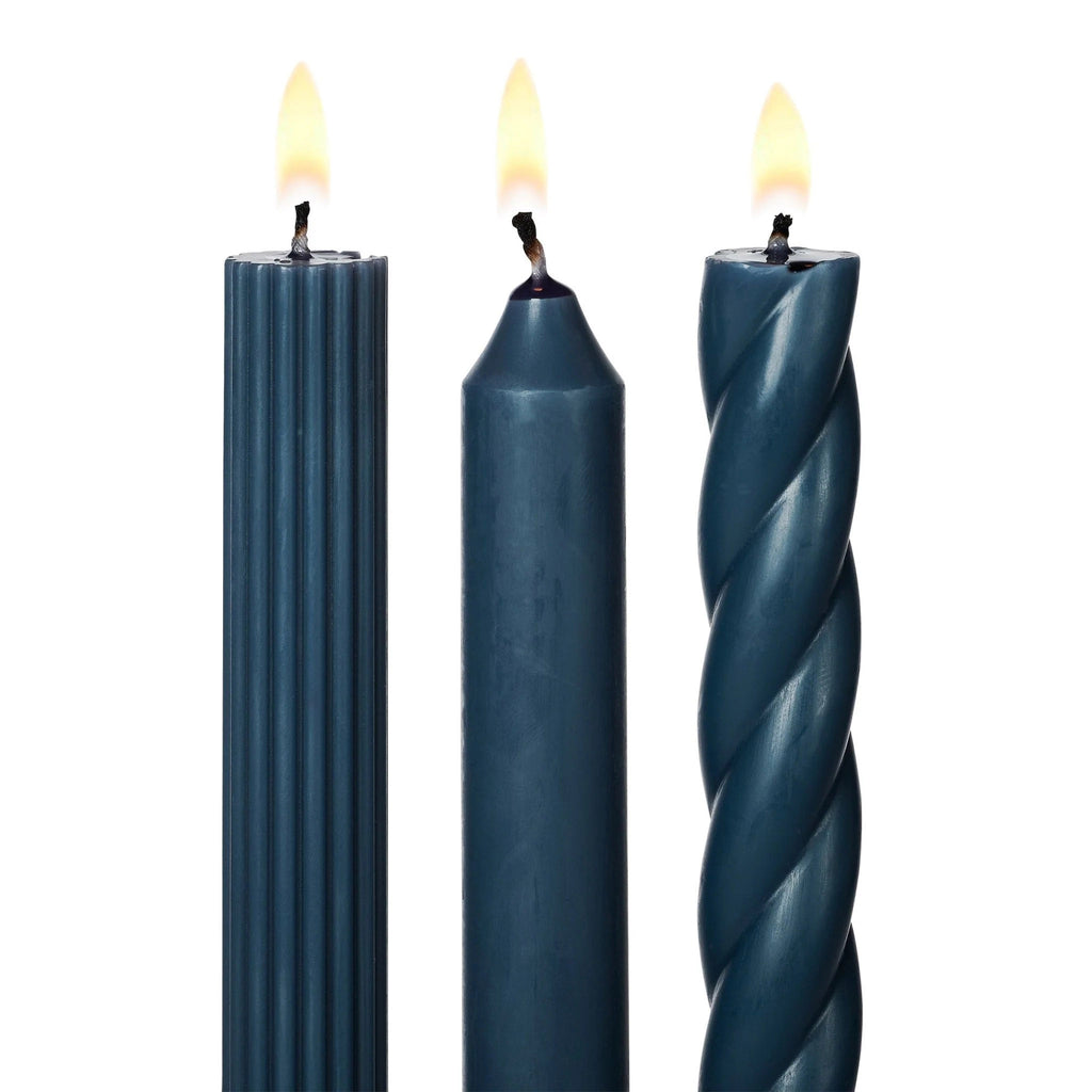 Illume Hidden Lake Deep Blue Set of 3 taper candles in assorted textures, detail of wick, lit.