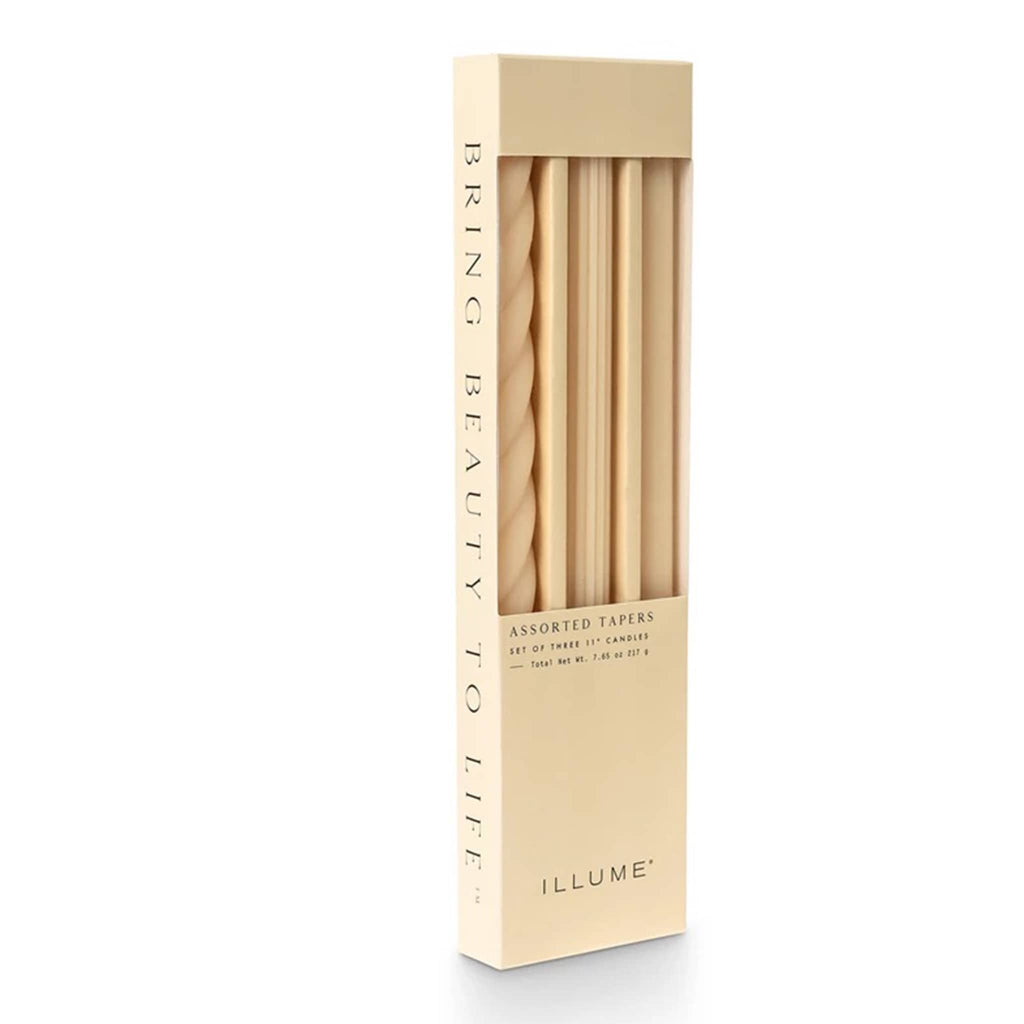 Illume Ivory Set of 3 taper candles in assorted textures in box packaging, front view.