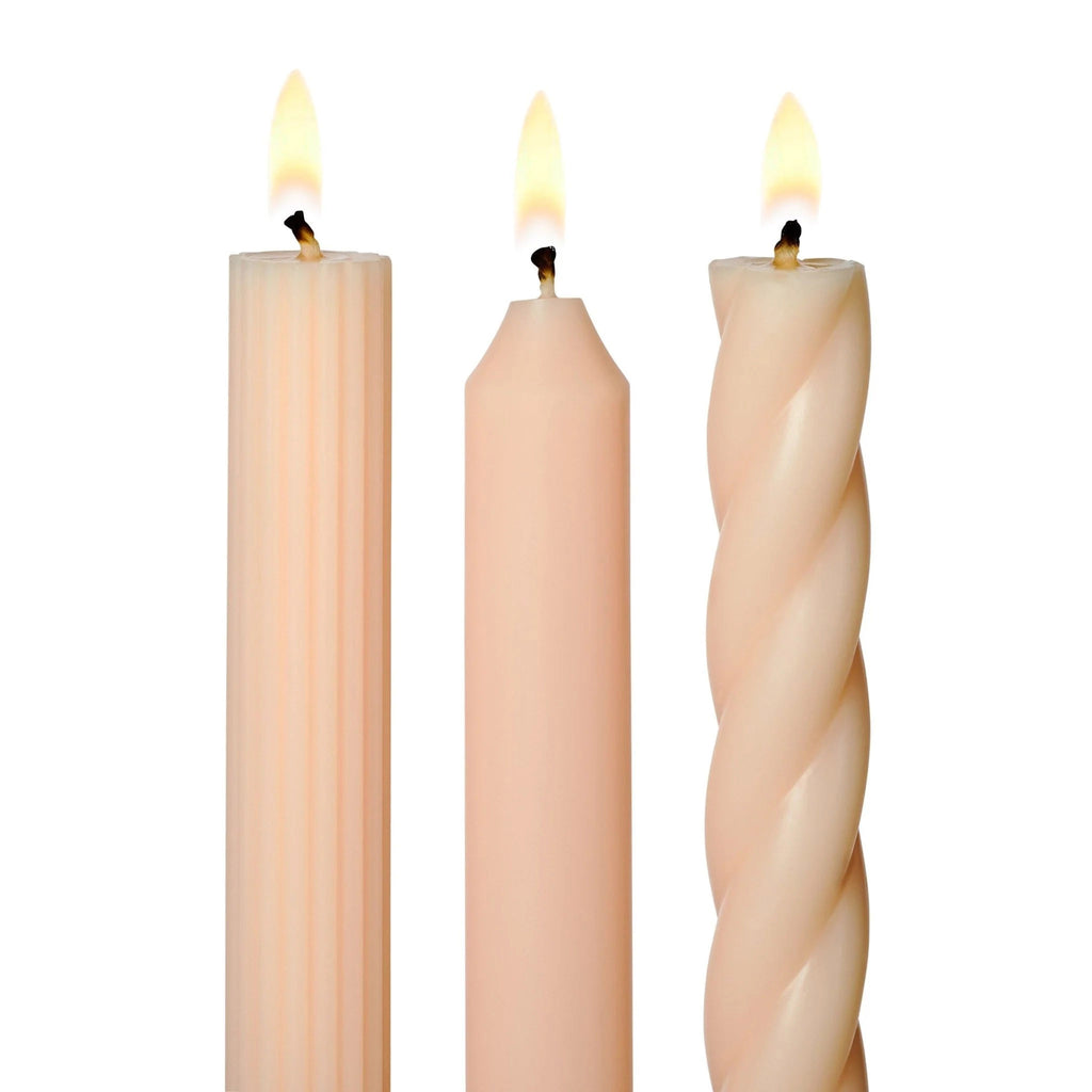 Illume Pale Blush Pink Set of 3 taper candles in assorted textures, detail of lit wicks.