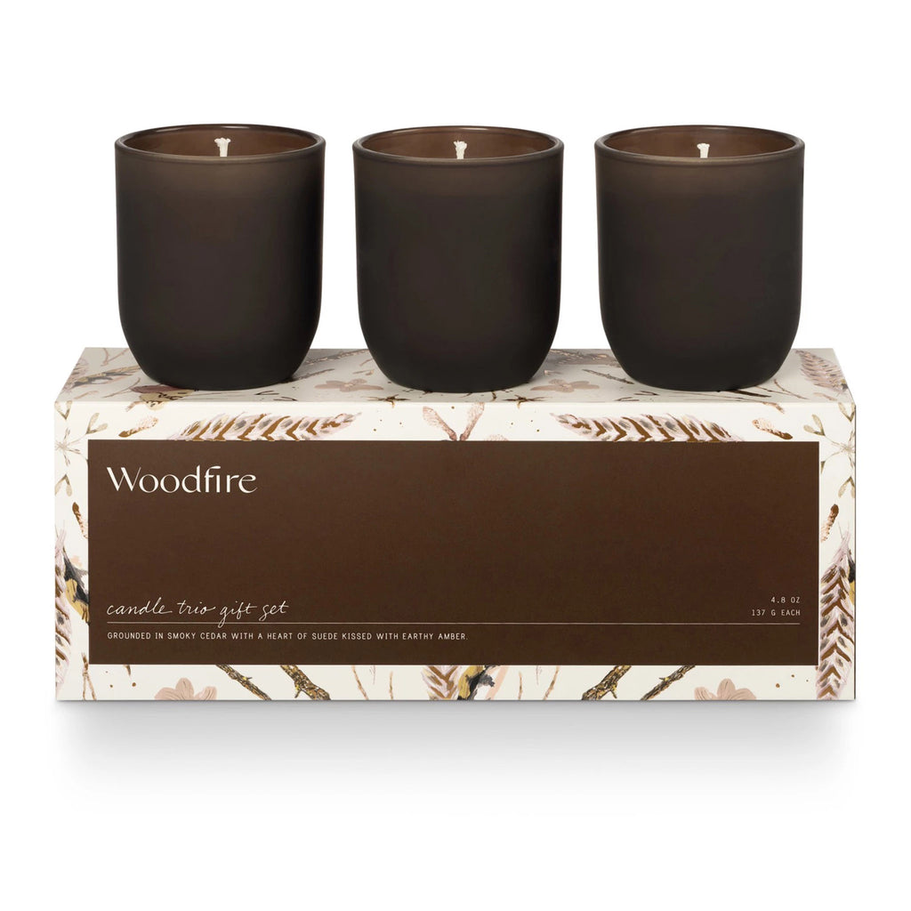 Illume Woodfire Candle Trio Gift Set, illustrated box packaging with 3 candles in matte brown glass vessels.