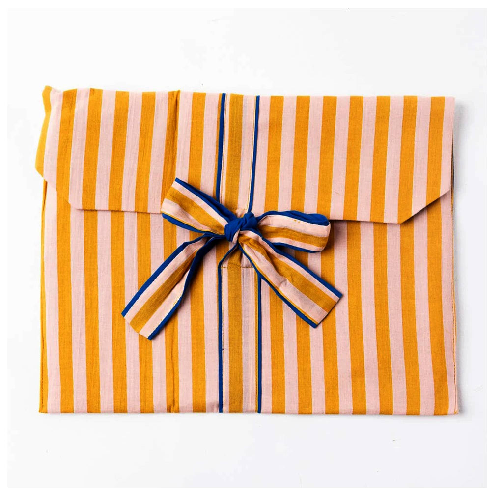 Mustard yellow and pink striped pajama set in matching fabric envelope packaging with bow.