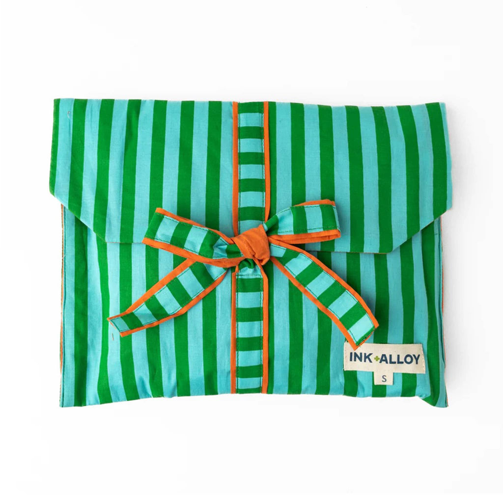 Green and blue striped pajama set in matching fabric envelope packaging with bow, on a white background.