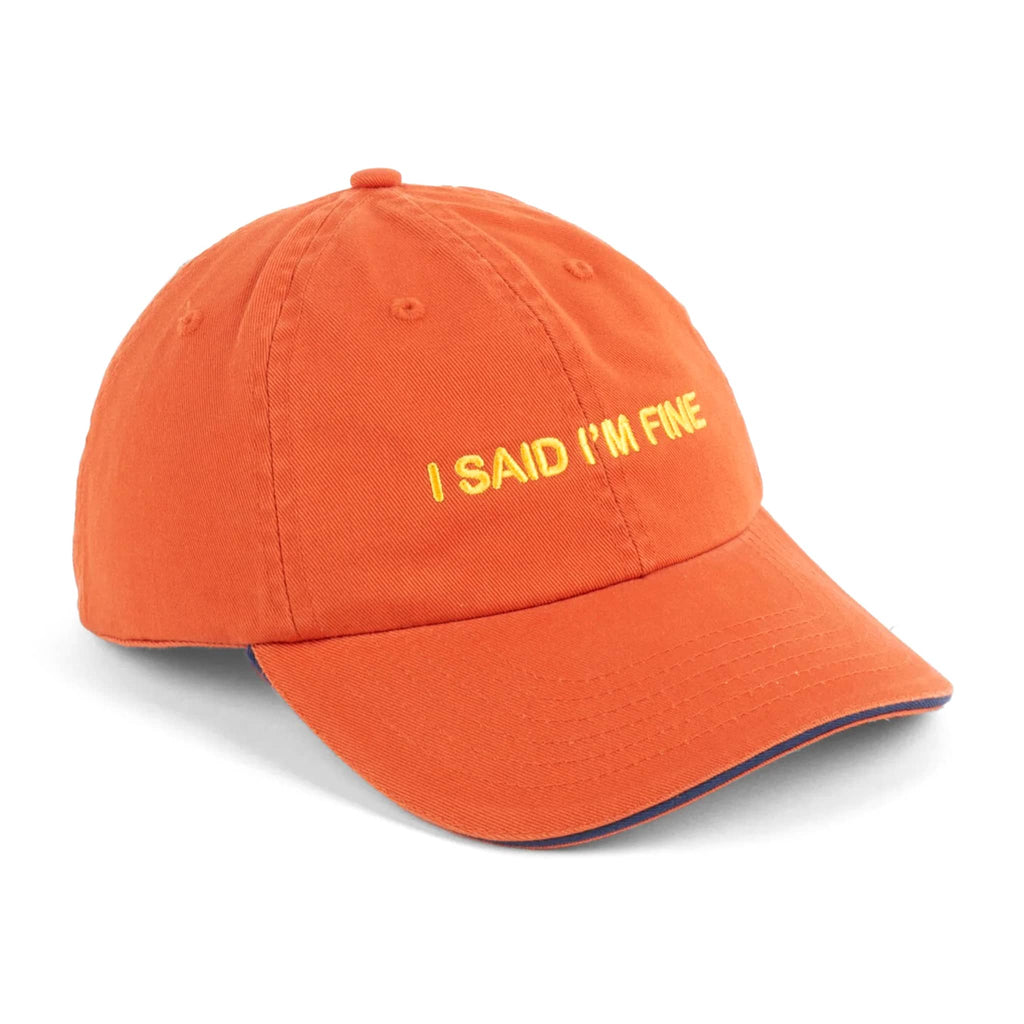 Orange ball cap with "i said i'm fine" in yellow embroidered lettering, on a white background.
