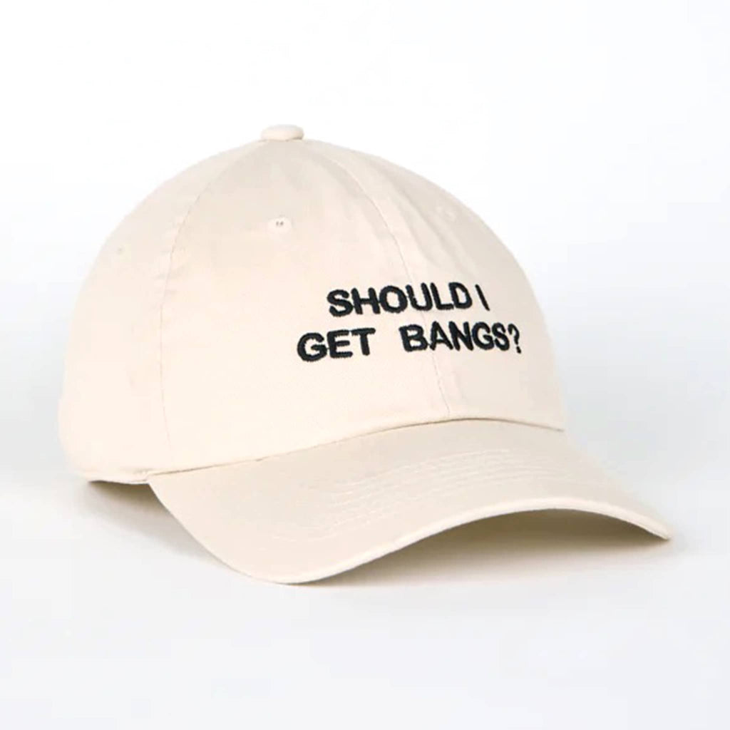 Beige cap with 'SHOULD I GET BANGS?' text on a white background.