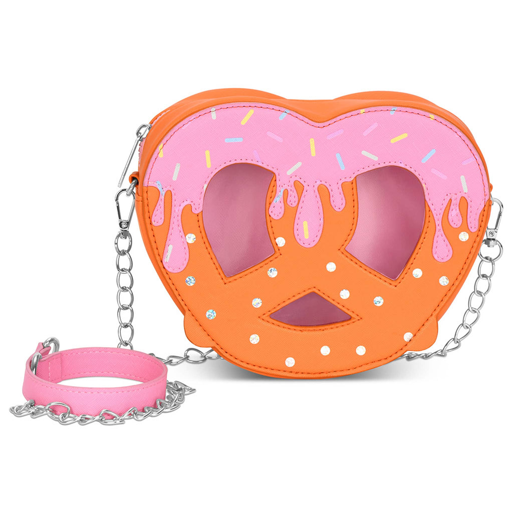 Pretzel-shaped bag with dark orange body, iridescent foil salt, pink frosting with sprinkles at the top and detachable chain link strap, front view, on a white background.