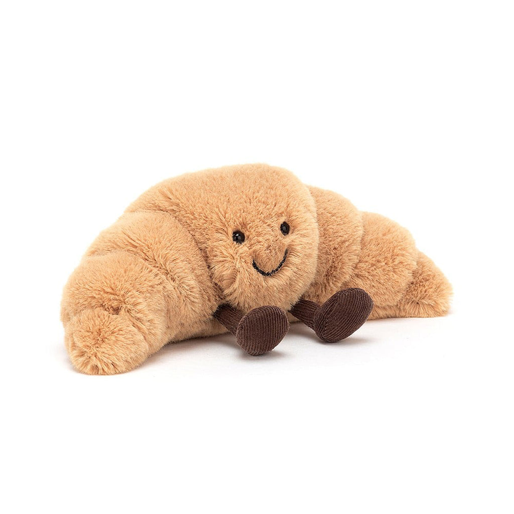 Jellycat small amuseable croissant plush toy, front view with brown corduroy feet, black bead eyes and a black stitched smile.