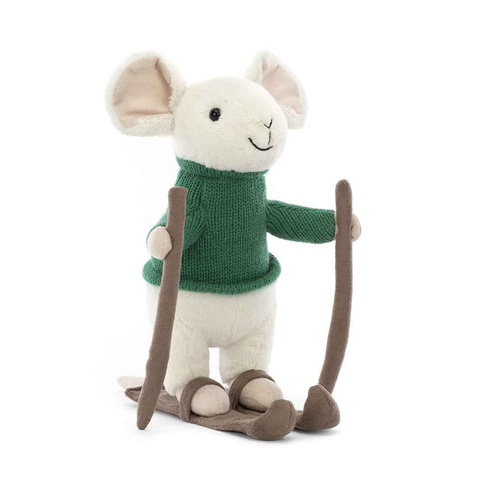 Jellycat Merry Mouse Skiing, white plush mouse with a green knit sweater on suede texture skis with poles, front view.