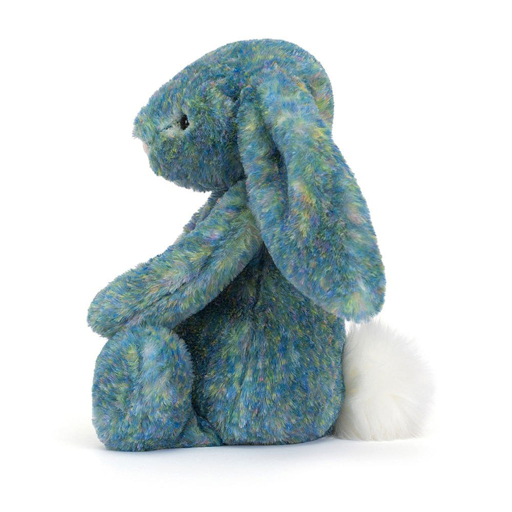 Jellycat Medium Bashful Luxe Bunny Azure plush toy in sitting position with pink nose and black bead eyes and colorful blue and green fur, side view.