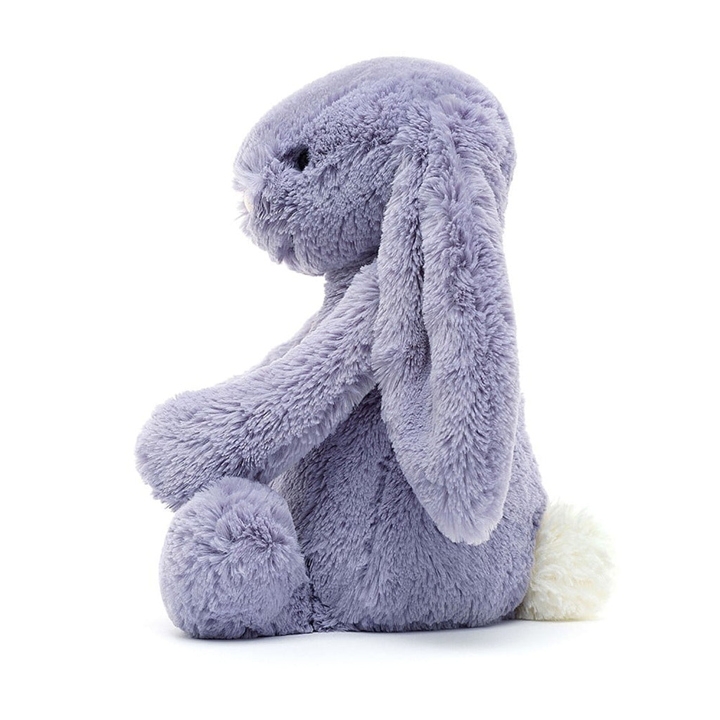 Jellycat Medium Bashful Viola Bunny plush toy with light purple fur, a pink nose and black bead eyes in sitting position, side view.