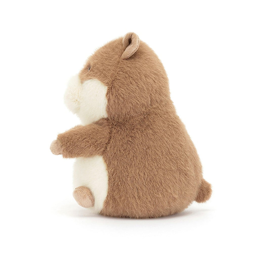 Jellycat Gordy Guinea Pig plush toy with tan and white fur, black bead eyes and a stitched pink nose, side view.