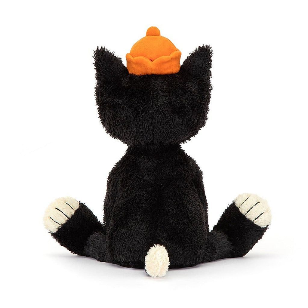 Jellycat Medium Jack Cat Original Plush Toy, black cat with white muzzle, tummy, tail and paws, with an orange hat on top, back view in sitting position.