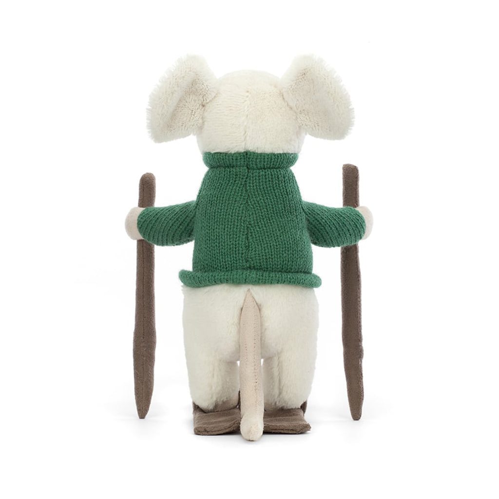 Jellycat Merry Mouse Skiing, white plush mouse with a green knit sweater on suede texture skis with poles, back view.