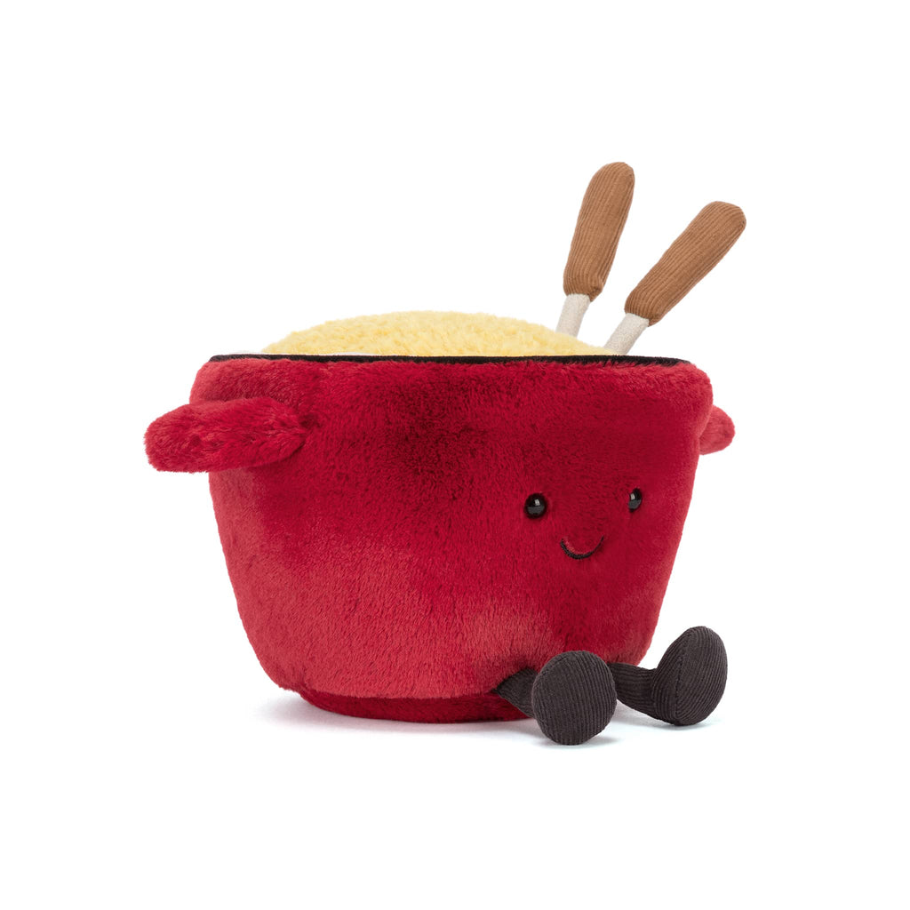 Plush red cheese fondue pot with a smiling face and fondue forks, front angle view on a white background.