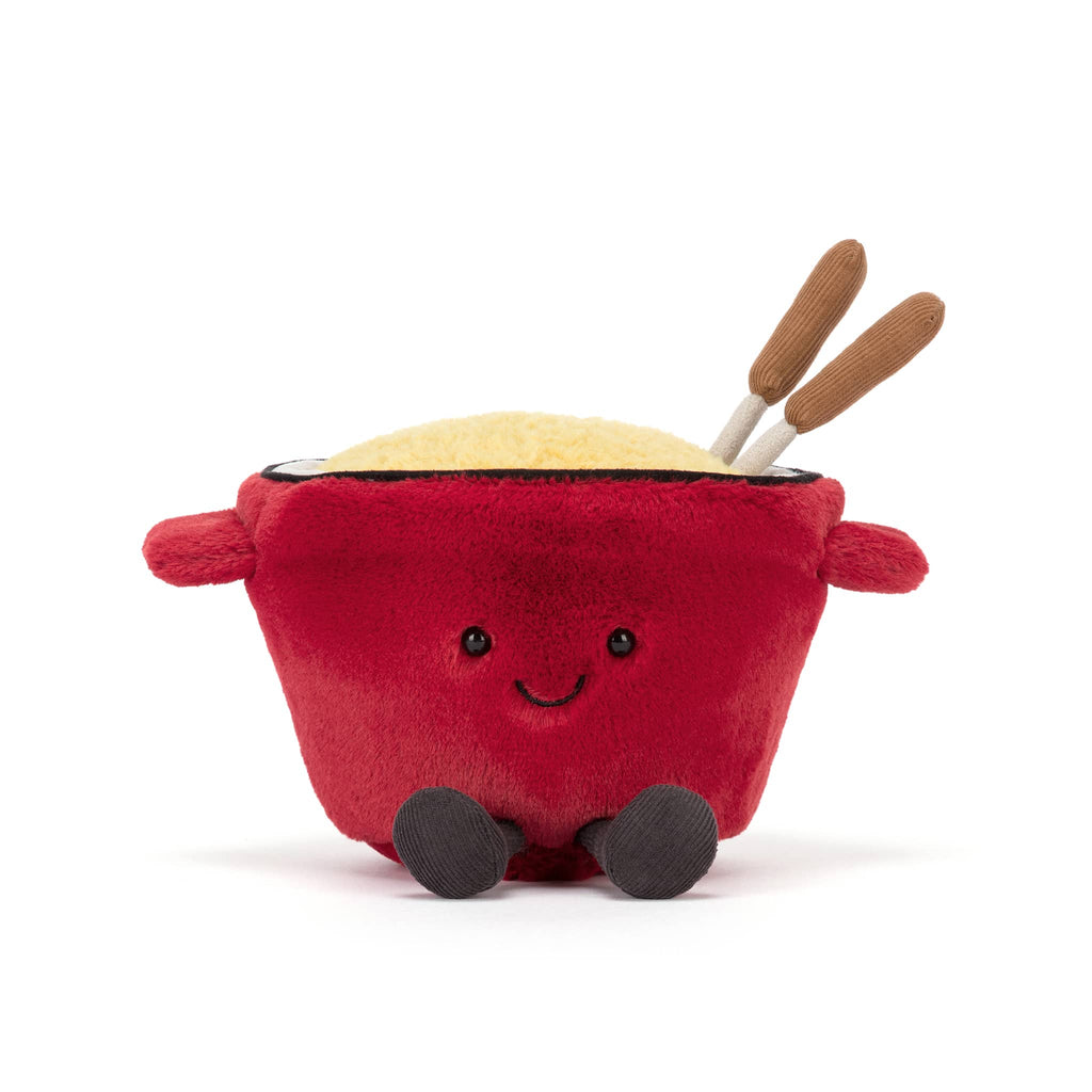 Plush red cheese fondue pot with a smiling face and fondue forks, front view on a white background.
