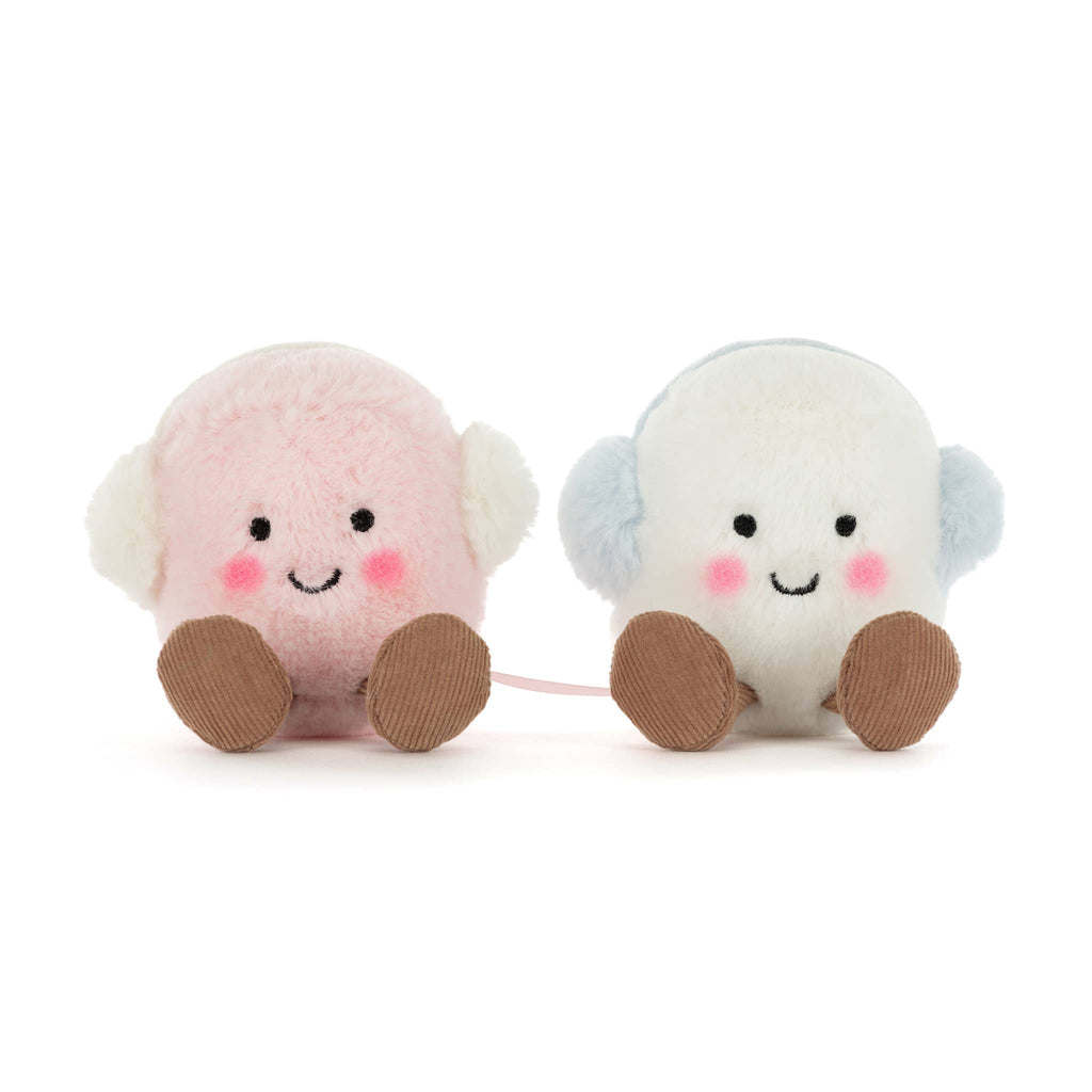A pink and a white plush marshmallow with earmuffs, front view on a white background.