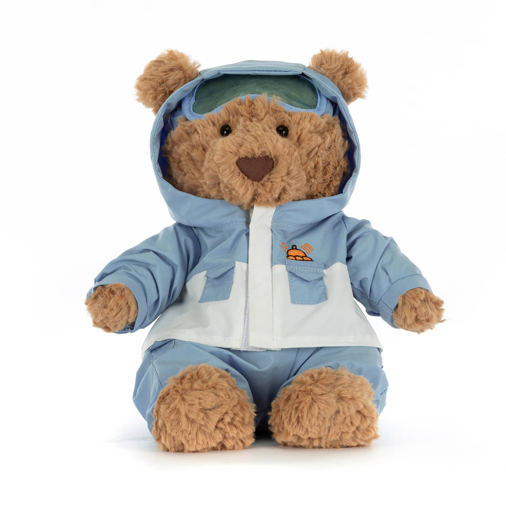 Plush teddy bear wearing a blue and white snowsuit, front view on a white background.