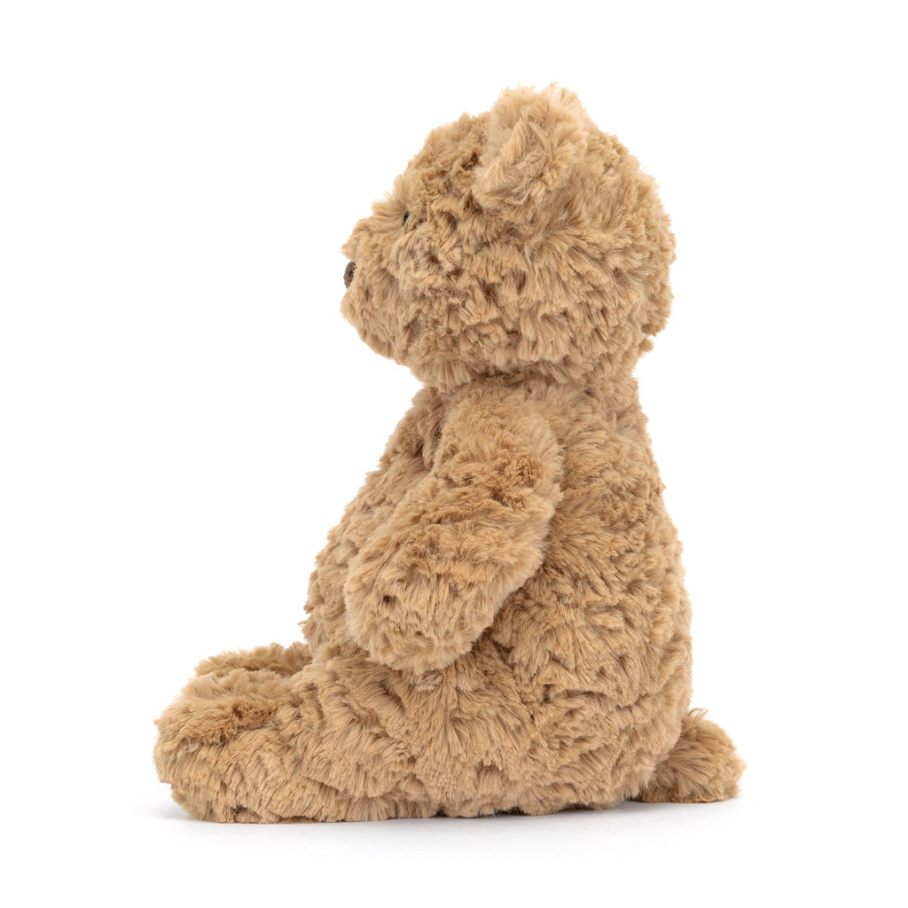 Jellycat Bartholomew plush teddy bear, side view, on a white background.