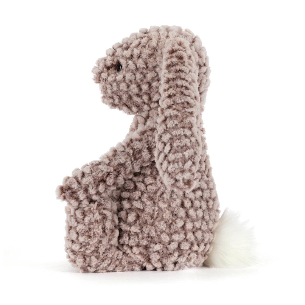 Plush bunny toy with brown textured fur, side view, on a white background.