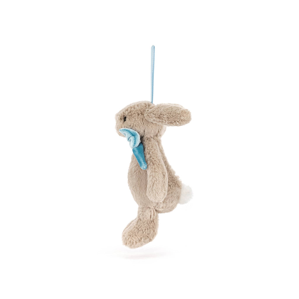 Plush beige bunny ornament with a blue bow tie, side view, on a white background.