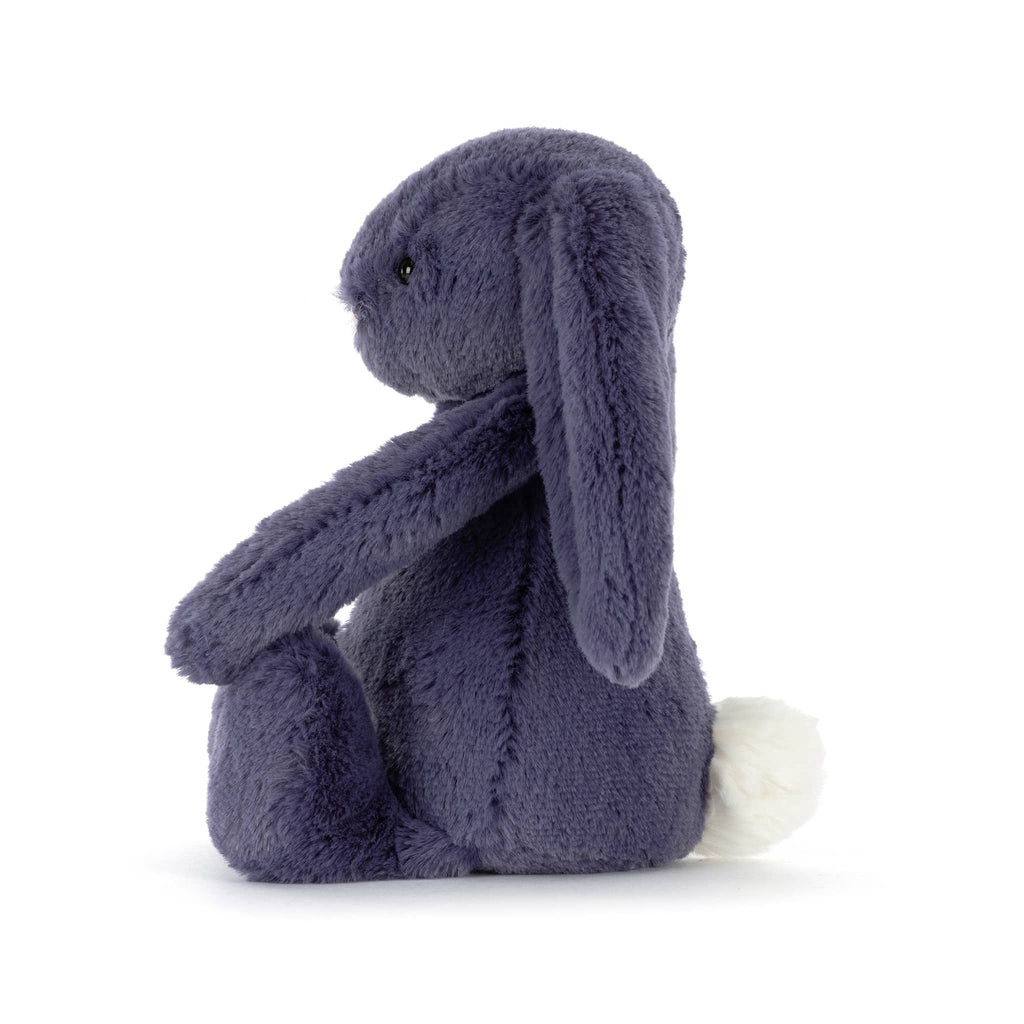 Dark blue plush bunny toy, side view, on a white background.