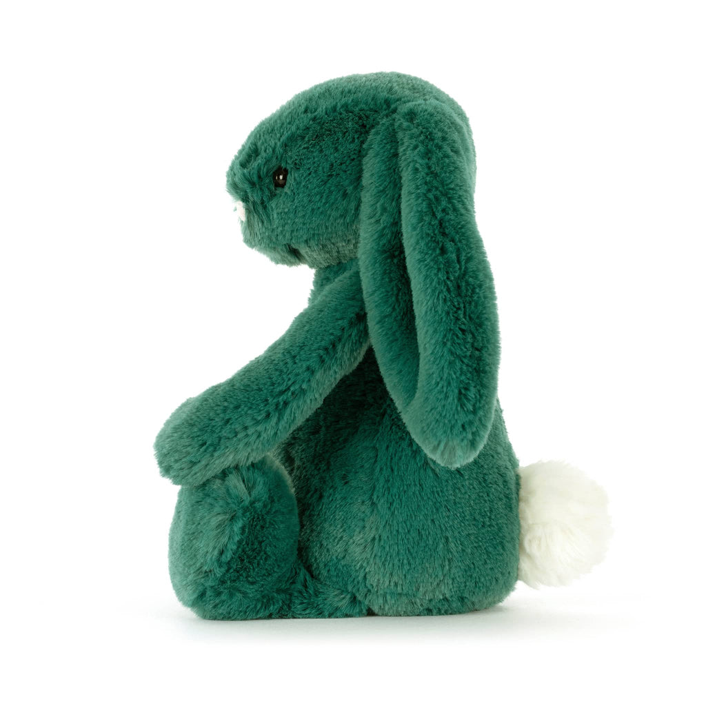 Green plush bunny toy, side view, on a white background.