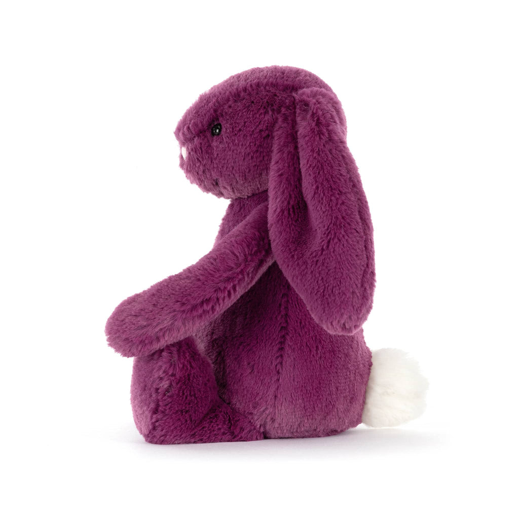 Purple plush bunny toy, side view, on a white background.